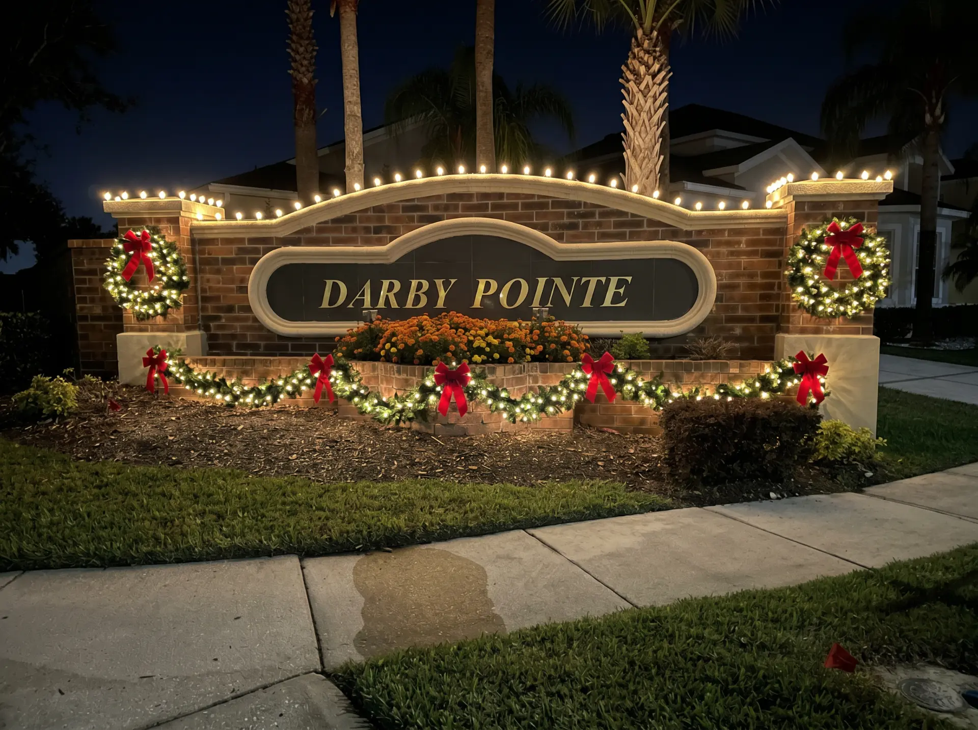 Holiday wreaths and garland on the Darby Pointe community entrance in Winter Park, FL